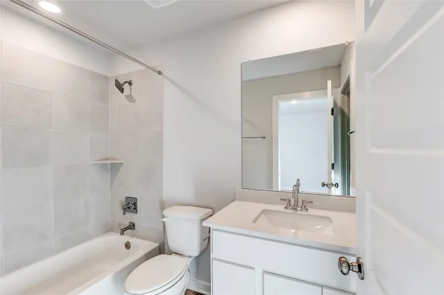a bathroom with a sink toilet vanity and tub