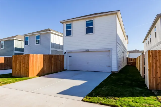a view of a house with a backyard