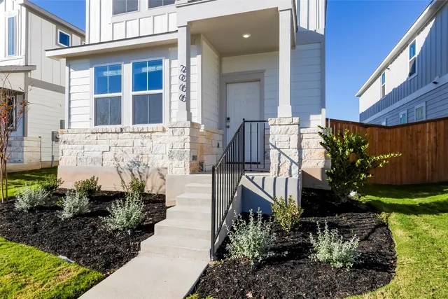 a front view of a house with garden