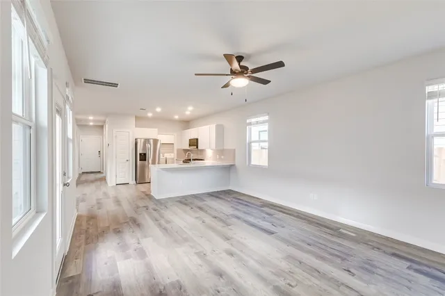 a view of a kitchen with wooden floor and a kitchen