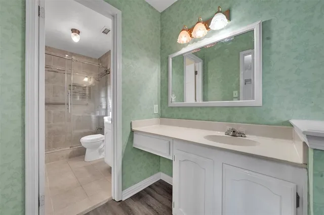 a bathroom with a sink vanity and a mirror