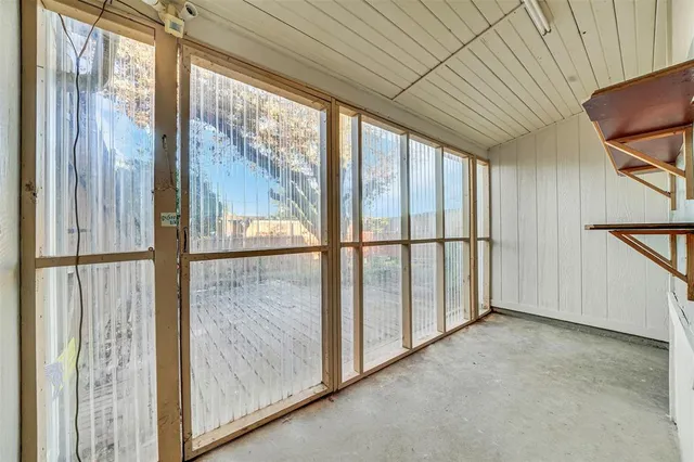 a view of a backyard with large trees and plants