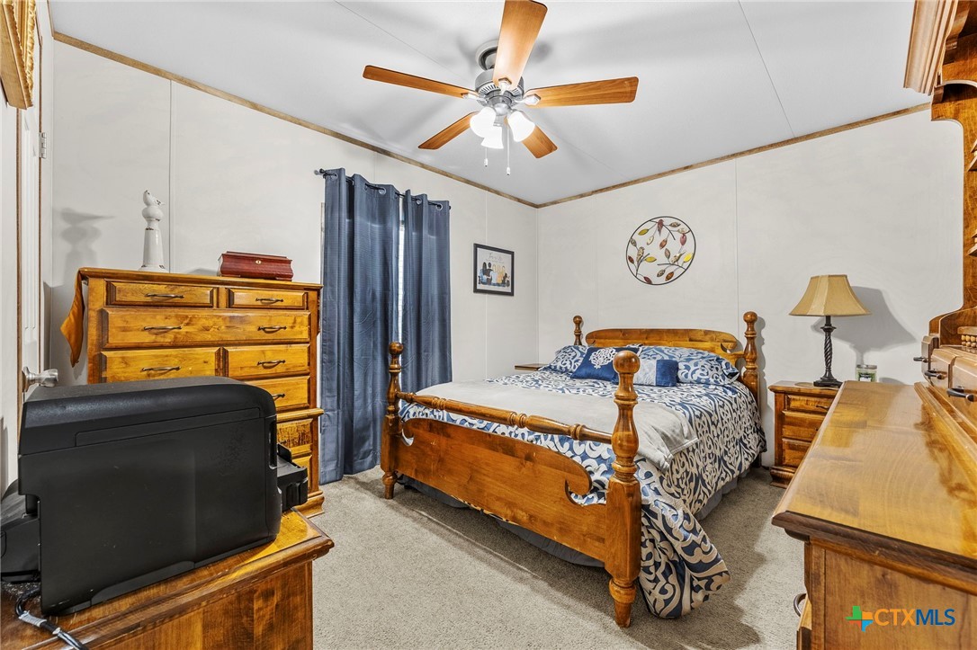 300 Private Road 3221 Kempner, TX 76539 - Photo 17 of 32 a bedroom with a bed and wooden floor