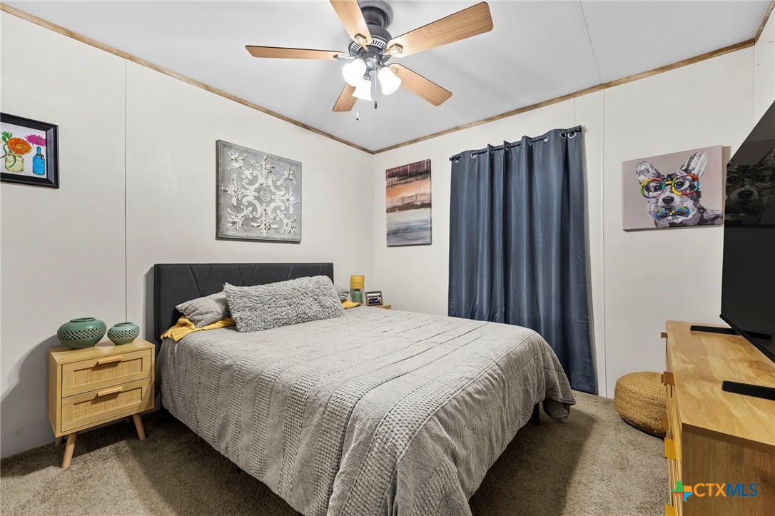 300 Private Road 3221 Kempner, TX 76539 - Photo 18 of 32 a bedroom with a bed and a flat screen tv