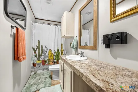 a bedroom with bed and wooden floor