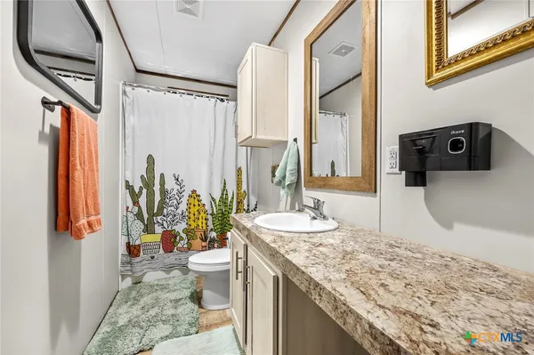 a bedroom with bed and wooden floor