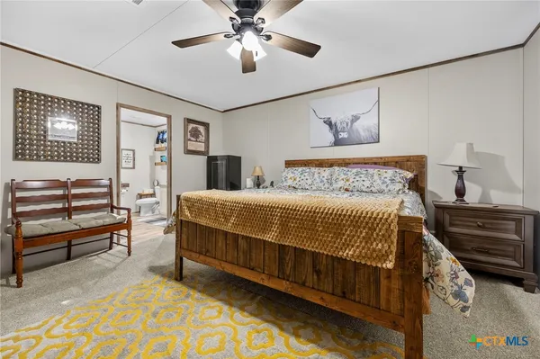 a bathroom with a granite countertop toilet sink and mirror