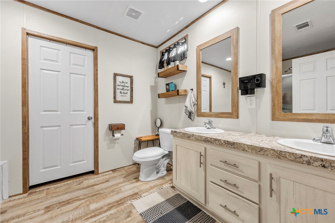 300 Private Road 3221 Kempner, TX 76539 - Photo 23 of 32 a bathroom with a granite countertop toilet sink and mirror