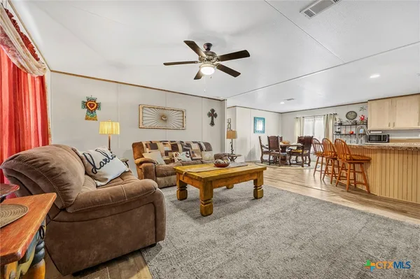a kitchen with white cabinets and appliances