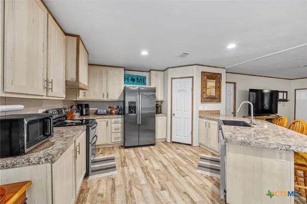 a kitchen with a stove and white cabinets