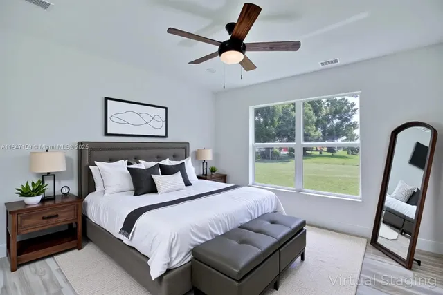 a bed room with a bed and a large window