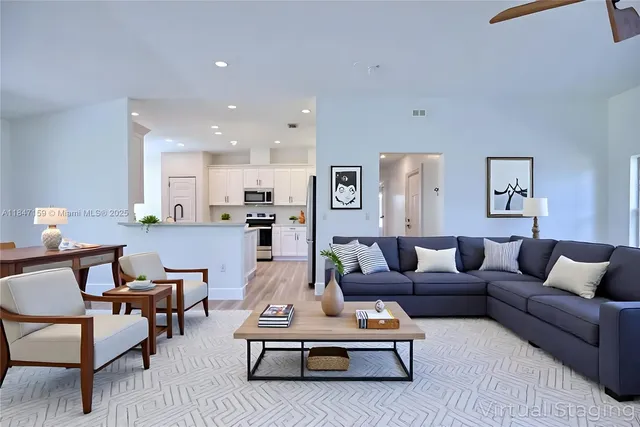 a living room with furniture a rug and a table