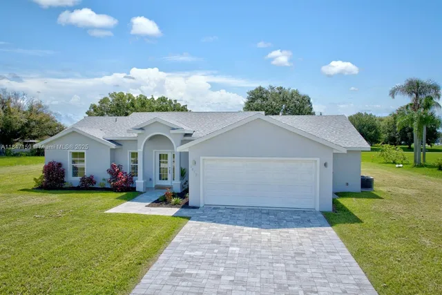 a view of a house with yard and a garden