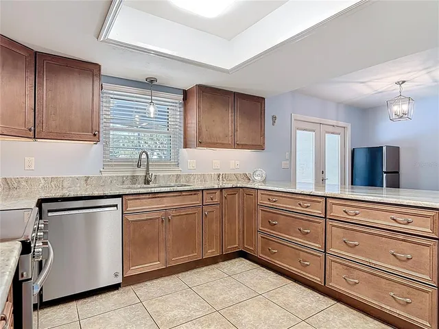 a kitchen with stainless steel appliances white cabinets white stove a microwave and a refrigerator