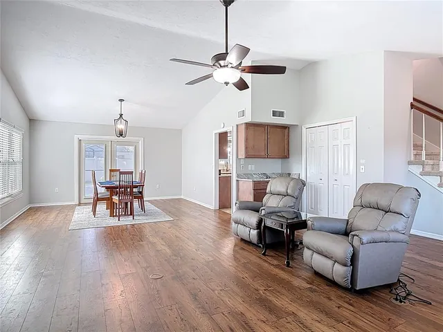 a living room with furniture and a chandelier