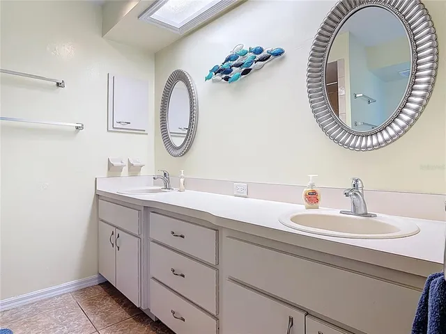 an empty room with a window and a ceiling fan