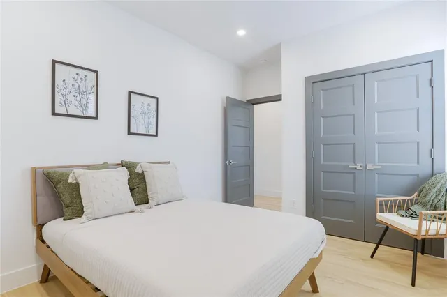 a bedroom with a bed and a chair