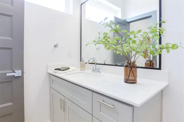 a bathroom with a sink a vanity and a mirror