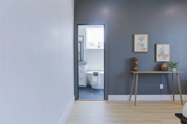 a view of a hallway with bathroom