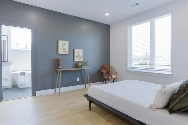 a bedroom with a bed and a table