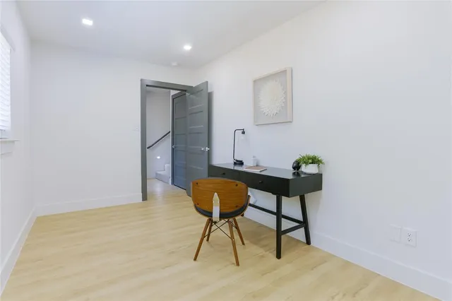 a workspace room with furniture and wooden floor