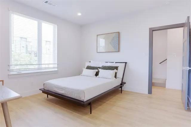 a bedroom with a bed and a window