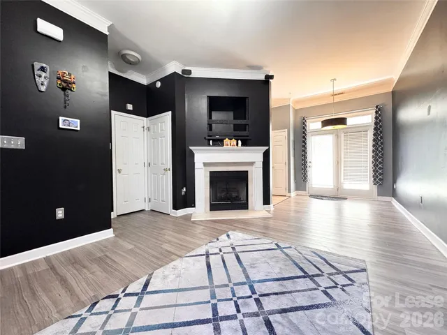 a view of a livingroom with a fireplace cabinet and window