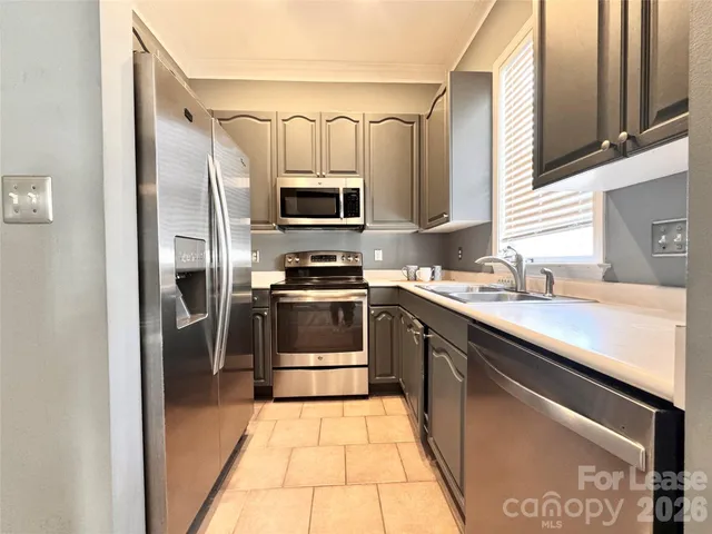 a kitchen with a sink stainless steel appliances and cabinets