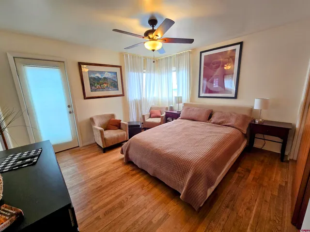 a spacious bedroom with a bed and a desk