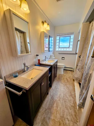 a spacious bathroom with a granite countertop sink and a mirror