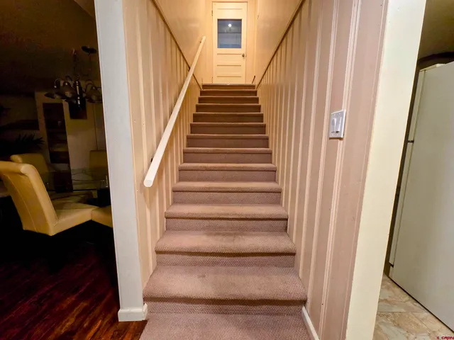 a view of staircase with black walls