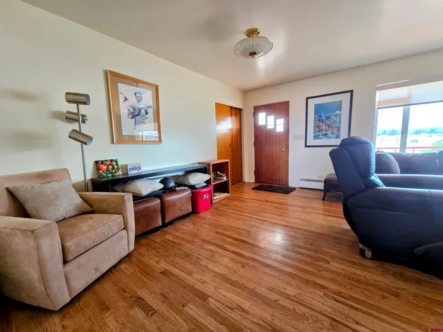 a living room with furniture and wooden floor