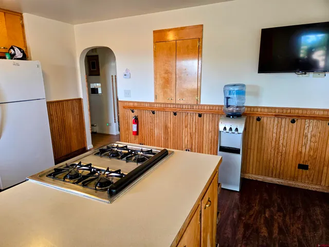 a kitchen with a stove and a refrigerator