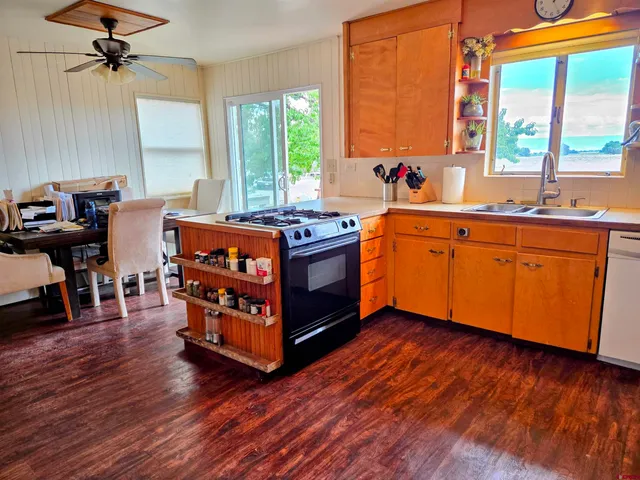 a kitchen with stainless steel appliances granite countertop a stove and wooden floor