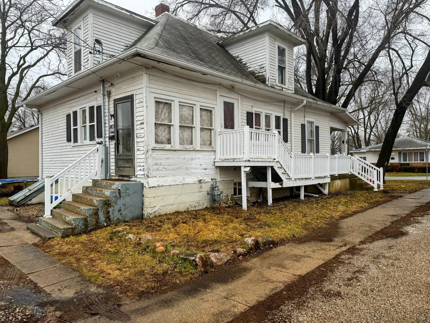 506 South Beech Street Arthur, IL 61911 - Photo 6 of 7 a view of a white house with a large window and a yard
