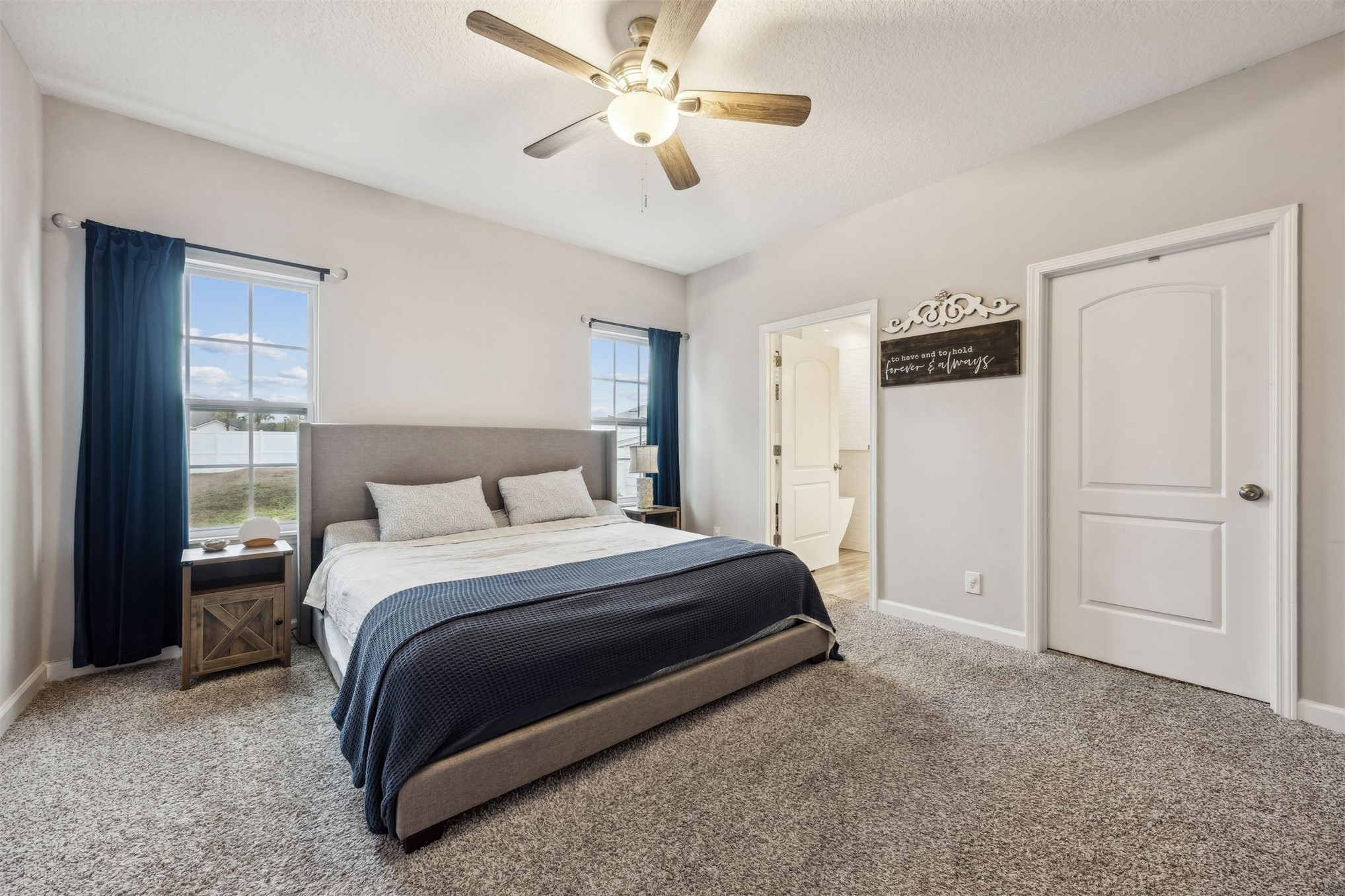 96718 Blackrock Road Yulee, FL 32097 - Photo 4 of 54 a spacious bedroom with a bed and a ceiling fan