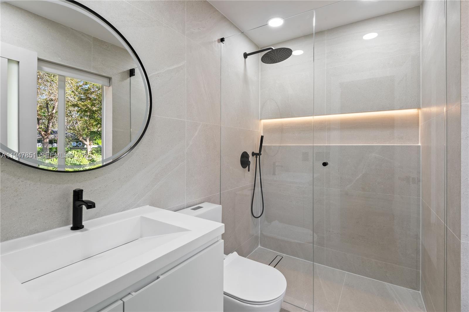 8420 Southwest 179th Street Palmetto Bay, FL 33157 - Photo 14 of 27 a bathroom with a sink toilet and shower