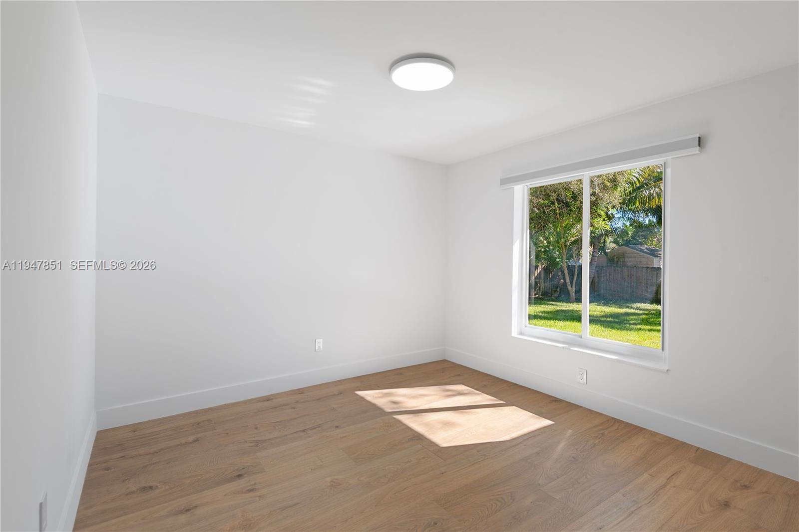 8420 Southwest 179th Street Palmetto Bay, FL 33157 - Photo 16 of 27 an empty room with a window