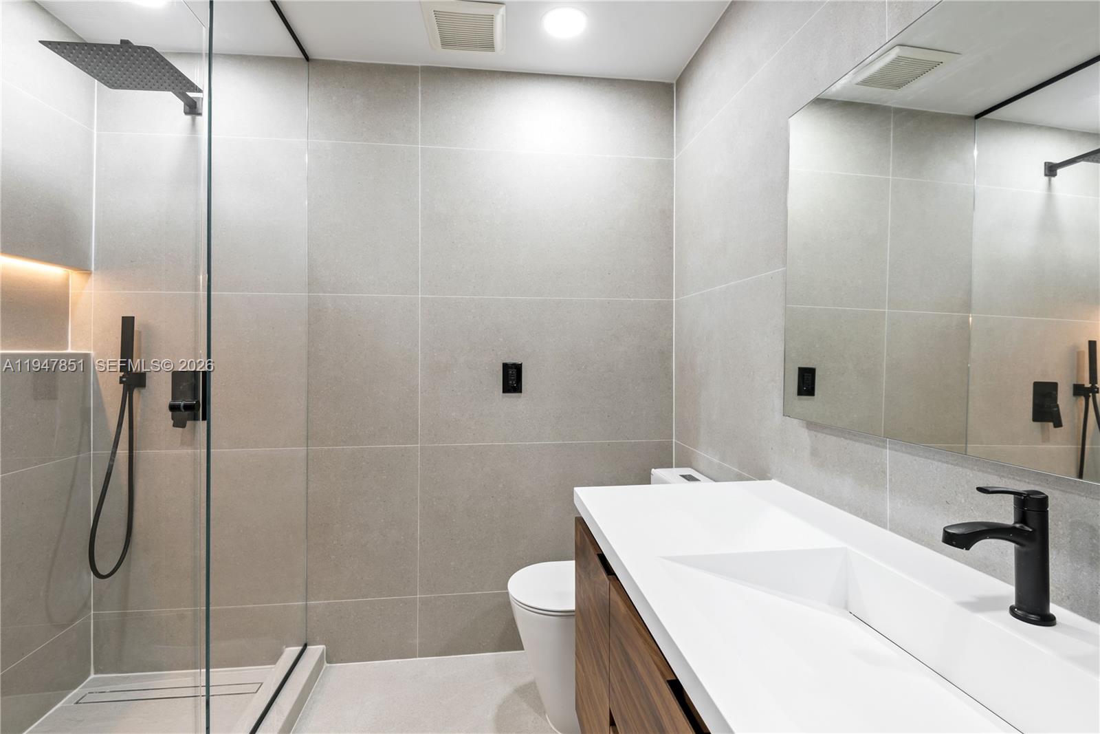 8420 Southwest 179th Street Palmetto Bay, FL 33157 - Photo 19 of 27 a bathroom with a sink a toilet and shower