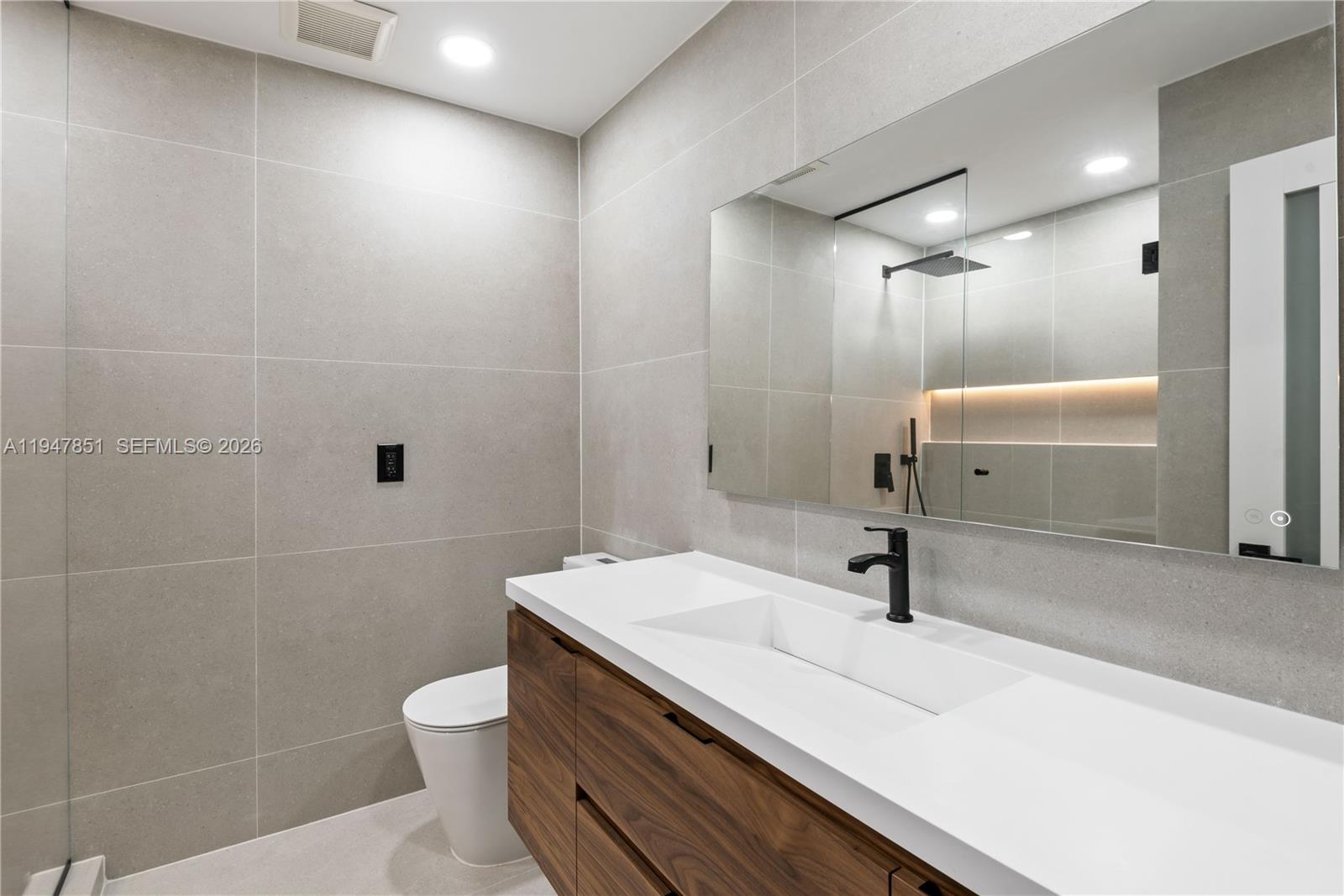 8420 Southwest 179th Street Palmetto Bay, FL 33157 - Photo 20 of 27 a bathroom with a sink a toilet and shower