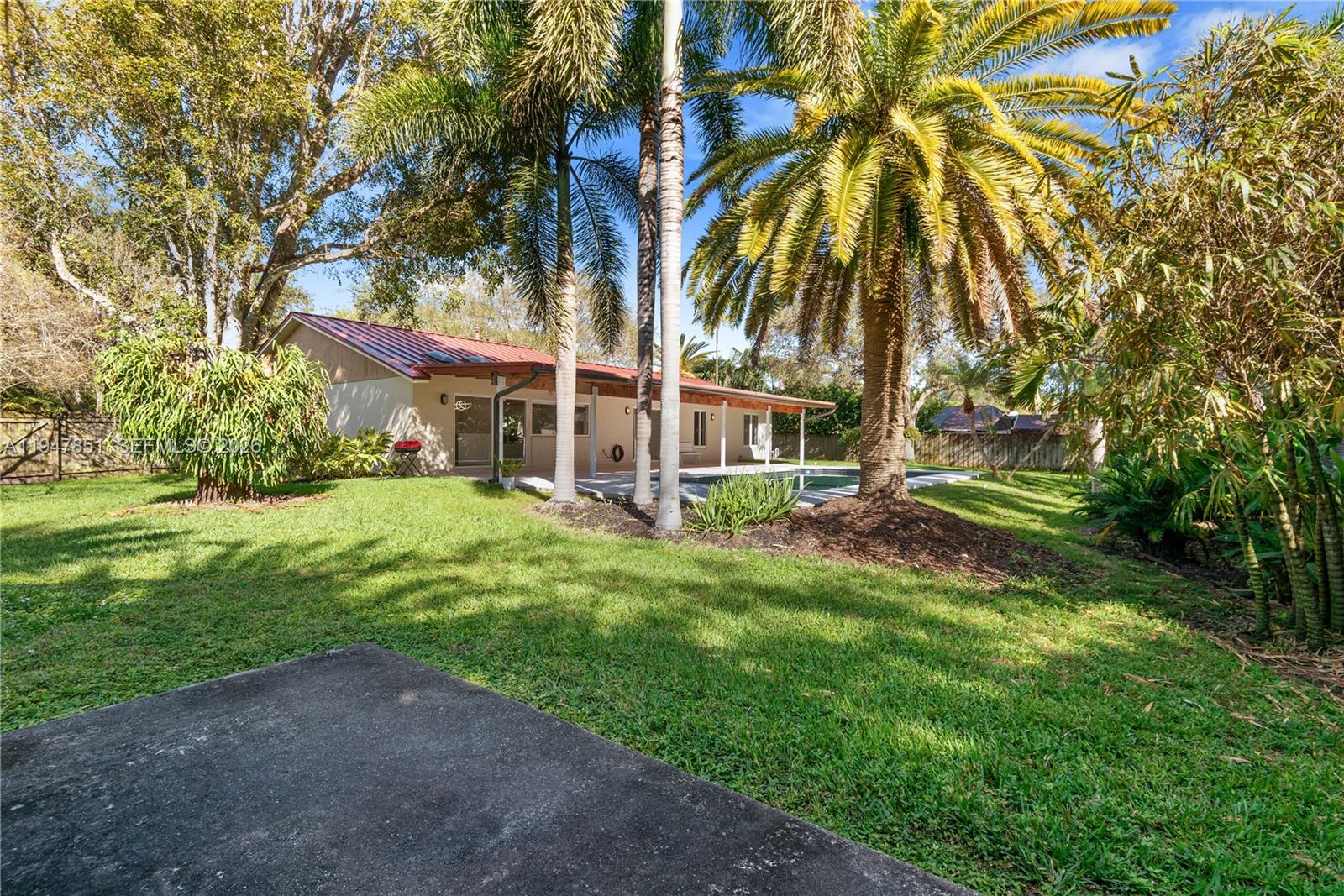 8420 Southwest 179th Street Palmetto Bay, FL 33157 - Photo 24 of 27 a view of a house with a yard