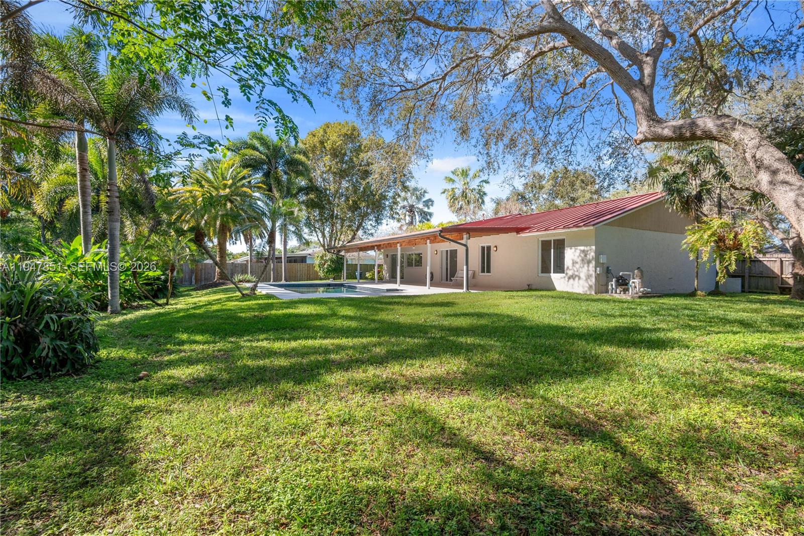8420 Southwest 179th Street Palmetto Bay, FL 33157 - Photo 25 of 27 a front view of house with yard and green space