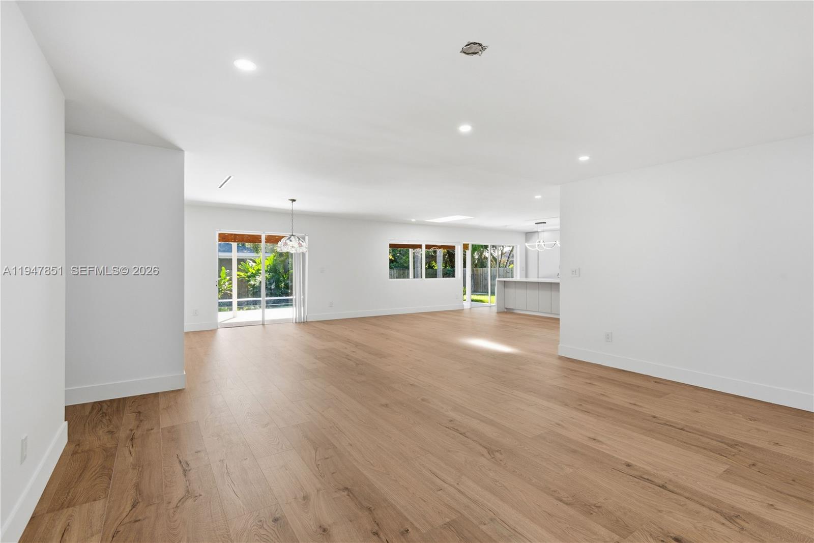 8420 Southwest 179th Street Palmetto Bay, FL 33157 - Photo 3 of 27 a view of a livingroom with wooden floor and a window