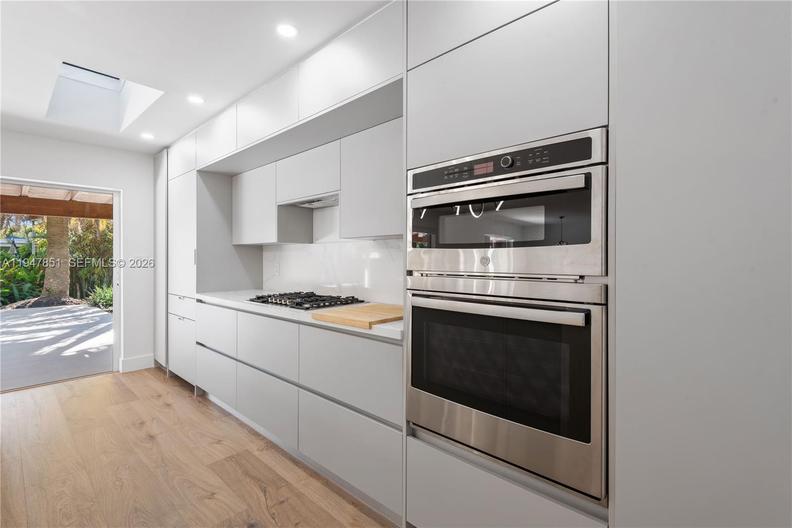 8420 Southwest 179th Street Palmetto Bay, FL 33157 - Photo 7 of 27 a kitchen with a stove and a microwave