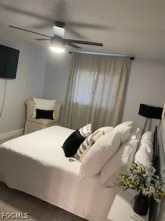 a bedroom with a bed and a potted plant