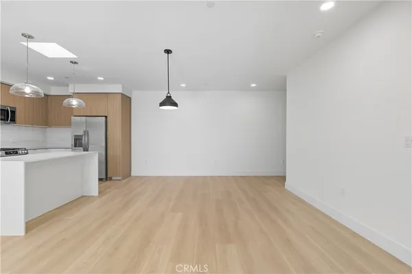 a view of a kitchen with a sink and a refrigerator