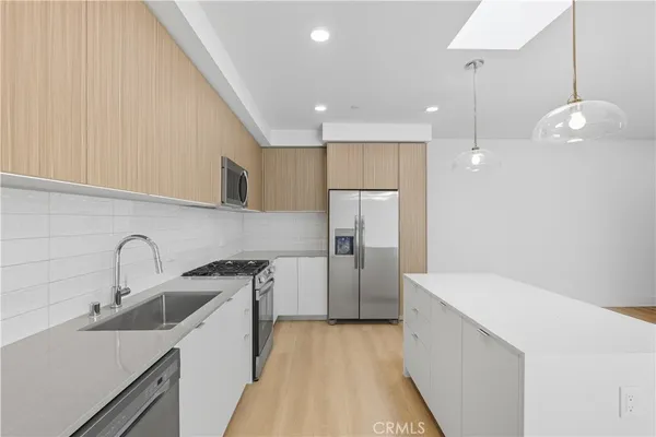 a kitchen with a sink a refrigerator and a stove