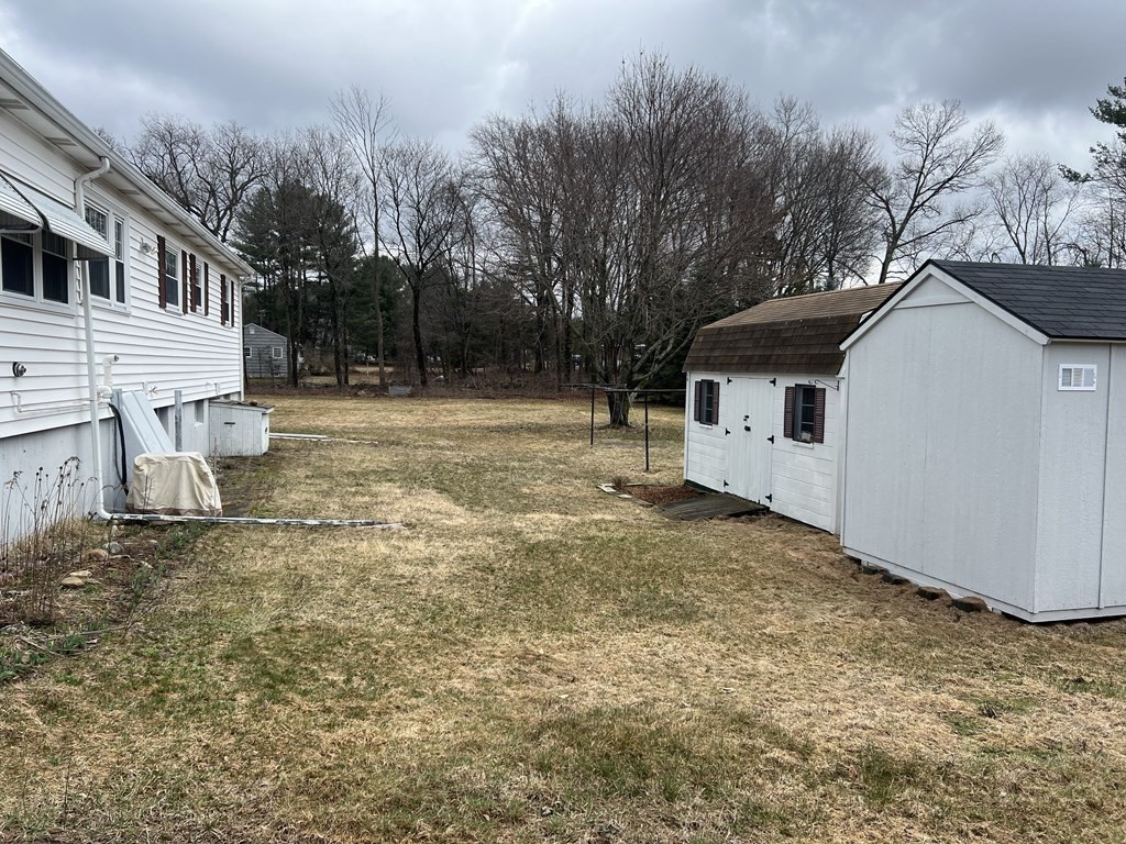 39 Mill Road Chelmsford, MA 01824 - Photo 19 of 22 a backyard of a house with large trees and outdoor space