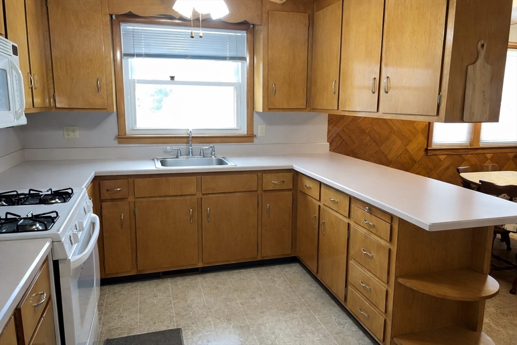 39 Mill Road Chelmsford, MA 01824 - Photo 5 of 22 a kitchen with sink cabinets and window