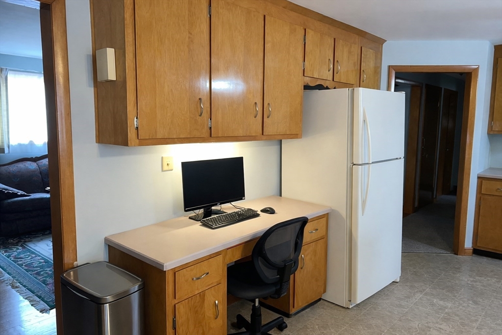 39 Mill Road Chelmsford, MA 01824 - Photo 6 of 22 a kitchen with a refrigerator a stove and a sink with wooden floor